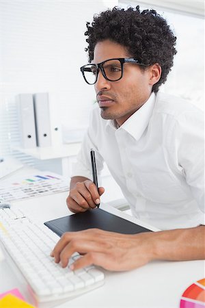 simsearch:400-07926810,k - Hipster designer working at his desk in his office Fotografie stock - Microstock e Abbonamento, Codice: 400-07727467