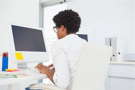 simsearch:400-07926810,k - Hipster designer working at his desk in his office Fotografie stock - Microstock e Abbonamento, Codice: 400-07727469