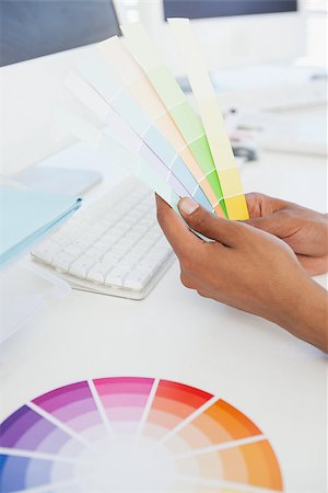 simsearch:400-07466593,k - Designer working at desk holding colour samples in his office Stock Photo - Budget Royalty-Free & Subscription, Code: 400-07727479