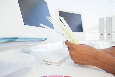 simsearch:400-07466593,k - Designer working at desk holding colour samples in his office Stock Photo - Budget Royalty-Free & Subscription, Code: 400-07727480