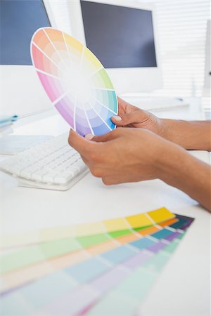simsearch:400-07466593,k - Designer working at desk holding colour wheel in his office Stock Photo - Budget Royalty-Free & Subscription, Code: 400-07727481