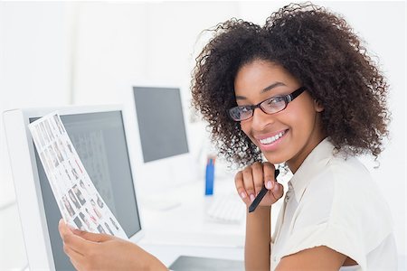 editor (female) - Pretty photo editor smiling at camera at desk in her office Stock Photo - Budget Royalty-Free & Subscription, Code: 400-07727590