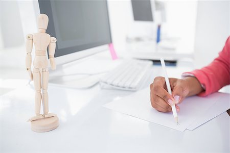 Casual graphic designer working at her desk sketching in her office Stock Photo - Budget Royalty-Free & Subscription, Code: 400-07727615