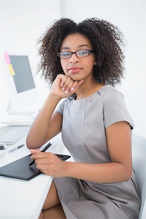 editor (female) - Young pretty designer smiling at camera at her desk in her office Stock Photo - Budget Royalty-Free & Subscription, Code: 400-07727785