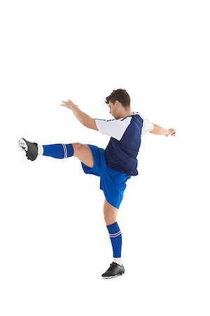 football man kicking white background - Football player in blue jersey kicking on white background Stock Photo - Budget Royalty-Free & Subscription, Code: 400-07727863
