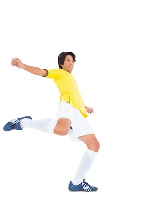 football man kicking white background - Football player in yellow kicking on white background Stock Photo - Budget Royalty-Free & Subscription, Code: 400-07727939