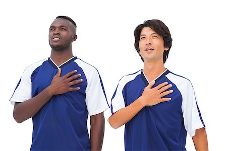 Football players in blue with hands on heart  on white background Stock Photo - Budget Royalty-Free & Subscription, Code: 400-07727978