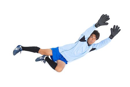 simsearch:622-08123209,k - Goalkeeper in blue making a save on white background Stock Photo - Budget Royalty-Free & Subscription, Code: 400-07728022