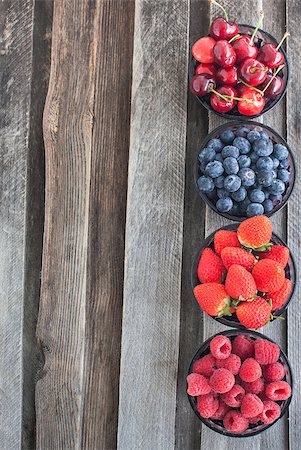 simsearch:400-08672192,k - Fresh cherry, strawberry, blueberry and raspberry on wooden table, copy space Photographie de stock - Aubaine LD & Abonnement, Code: 400-07728258
