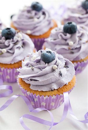 Tasty blueberry and lavender cupcakes on white background Stockbilder - Microstock & Abonnement, Bildnummer: 400-07728262