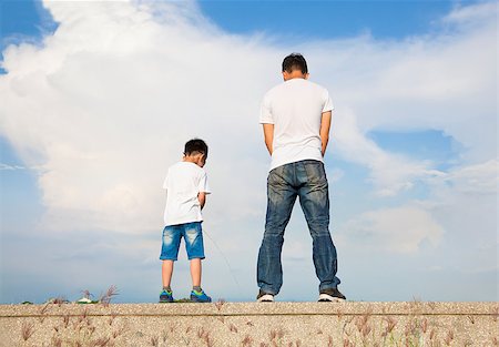 father and son standing on a stone platform and pee together Photographie de stock - Aubaine LD & Abonnement, Code: 400-07720007