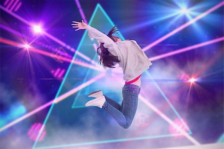 simsearch:400-07720894,k - Cheerful young woman jumping against digitally generated laser lights background Foto de stock - Super Valor sin royalties y Suscripción, Código: 400-07720931