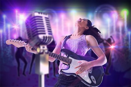 simsearch:400-07477109,k - Pretty girl playing guitar against digitally generated cool nightlife background Stockbilder - Microstock & Abonnement, Bildnummer: 400-07720948