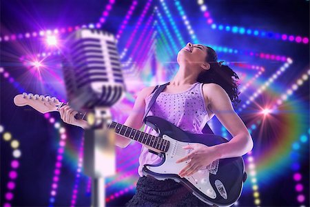 Pretty girl playing guitar against digitally generated star laser background Stock Photo - Budget Royalty-Free & Subscription, Code: 400-07720957