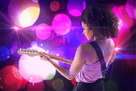 simsearch:400-07477109,k - Pretty girl playing guitar against digitally generated cool nightlife design Stockbilder - Microstock & Abonnement, Bildnummer: 400-07720964