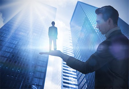 Composite image of businessman holding architect against low angle view of skyscrapers Stock Photo - Budget Royalty-Free & Subscription, Code: 400-07721177