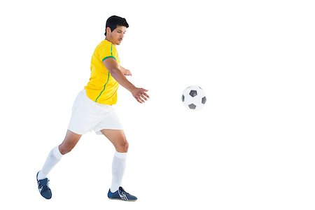 football man kicking white background - Football player in yellow kicking ball on white background Stock Photo - Budget Royalty-Free & Subscription, Code: 400-07721595