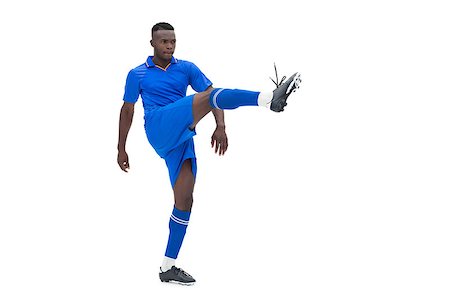 football man kicking white background - Football player in blue kicking on white background Stock Photo - Budget Royalty-Free & Subscription, Code: 400-07721697