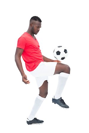 football man kicking white background - Football player in red jersey controlling ball on white background Stock Photo - Budget Royalty-Free & Subscription, Code: 400-07721724