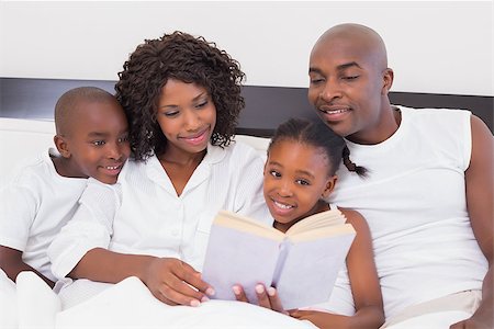 simsearch:400-05751566,k - Happy family reading book together in bed at home in the bedroom Stock Photo - Budget Royalty-Free & Subscription, Code: 400-07722176
