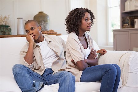 Unhappy couple arguing on the couch at home in the living room Stock Photo - Budget Royalty-Free & Subscription, Code: 400-07722264