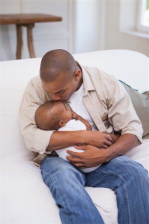 simsearch:614-03576718,k - Happy father spending time with baby on the couch at home in the living room Photographie de stock - Aubaine LD & Abonnement, Code: 400-07722268