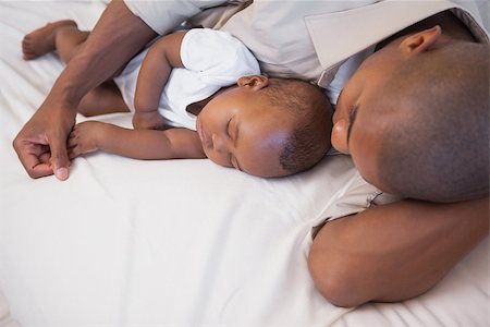 simsearch:614-03576718,k - Father napping with baby son on couch at home in the living room Photographie de stock - Aubaine LD & Abonnement, Code: 400-07722285
