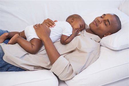 simsearch:614-03576718,k - Happy father napping with baby son on couch at home in the living room Photographie de stock - Aubaine LD & Abonnement, Code: 400-07722281