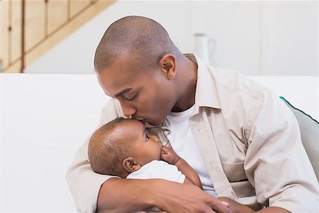 simsearch:614-03576718,k - Happy father spending time with baby on the couch at home in the living room Photographie de stock - Aubaine LD & Abonnement, Code: 400-07722499