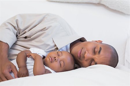 simsearch:614-03576718,k - Happy young father with baby son on couch at home in the living room Photographie de stock - Aubaine LD & Abonnement, Code: 400-07722525