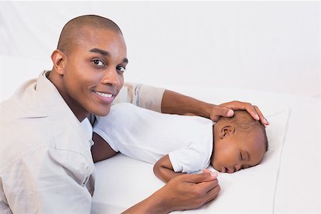 simsearch:614-03576718,k - Adorable baby boy sleeping while being watched by father at home in the living room Photographie de stock - Aubaine LD & Abonnement, Code: 400-07722537