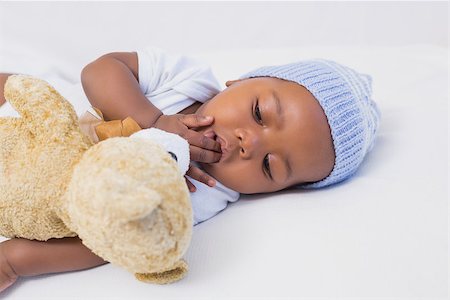 Adorable baby boy sleeping peacefully with teddy at home in the living room Stock Photo - Budget Royalty-Free & Subscription, Code: 400-07722544