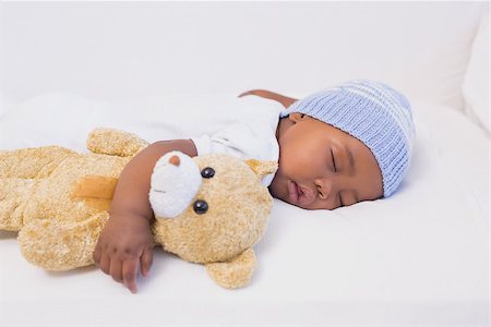 Adorable baby boy sleeping peacefully with teddy at home in the living room Stock Photo - Budget Royalty-Free & Subscription, Code: 400-07722540