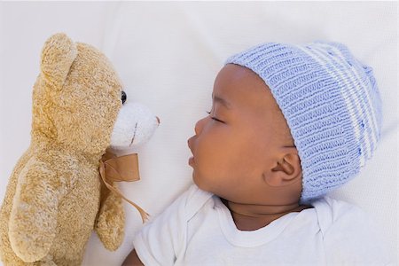 Adorable baby boy sleeping peacefully with teddy at home in the living room Stock Photo - Budget Royalty-Free & Subscription, Code: 400-07722543