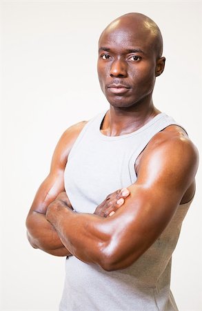simsearch:400-05082999,k - Portrait of a serious muscular man with arms crossed over white background Stock Photo - Budget Royalty-Free & Subscription, Code: 400-07723060