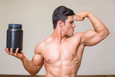 Portrait of a muscular man posing with nutritional supplement in gym Stock Photo - Budget Royalty-Free & Subscription, Code: 400-07723287