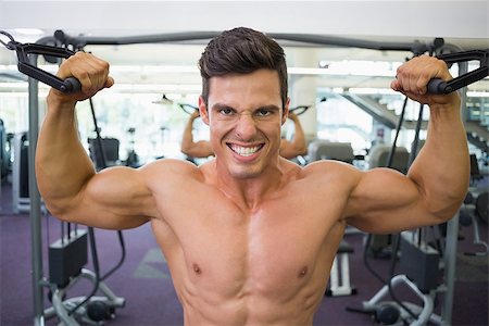 resistance band and men - Portrait of a shirtless young muscular man using resistance band in gym Stock Photo - Budget Royalty-Free & Subscription, Code: 400-07723406