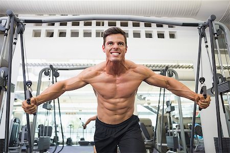 resistance band and men - Low angle view of a shirtless young muscular man using resistance band in gym Stock Photo - Budget Royalty-Free & Subscription, Code: 400-07723403