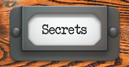 supersecretos - Secrets Inscription on File Drawer Label on a Wooden Background. Foto de stock - Super Valor sin royalties y Suscripción, Código: 400-07745333