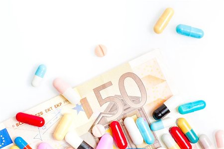 medical pills over fifty euro banknote on white background Stock Photo - Budget Royalty-Free & Subscription, Code: 400-07745766