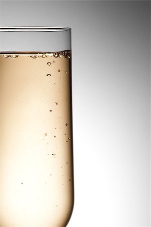 simsearch:400-04232915,k - half flute glass of champagne with bubbles against gray background Stock Photo - Budget Royalty-Free & Subscription, Code: 400-07745781
