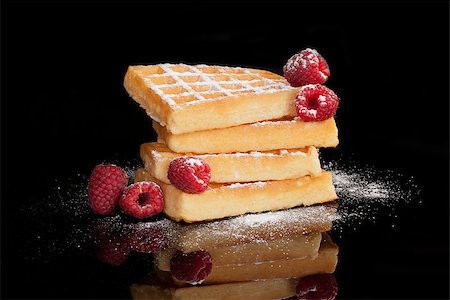 simsearch:400-08071201,k - Delicious waffle with fresh raspberries isolated on black background. Culinary traditional sweet dessert. Photographie de stock - Aubaine LD & Abonnement, Code: 400-07745943