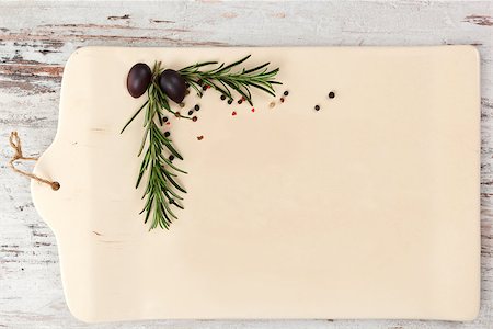 Empty ceramic kitchen board with rosemary and peppercorns in the corner on white wooden textured background as your copy space, top view. Culinary gastronomy background. Stock Photo - Budget Royalty-Free & Subscription, Code: 400-07745951