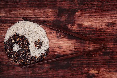 simsearch:400-05744487,k - White and wild rice forming a yin yang symbol with chopsticks on dark wooden background. Top view. Stock Photo - Budget Royalty-Free & Subscription, Code: 400-07745981