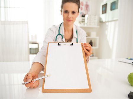 simsearch:400-07099823,k - Closeup on doctor woman pointing on clipboard Stock Photo - Budget Royalty-Free & Subscription, Code: 400-07746054