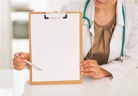 simsearch:400-07099823,k - Closeup on doctor woman pointing on clipboard Stock Photo - Budget Royalty-Free & Subscription, Code: 400-07746052