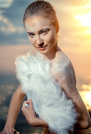 fashion accessories photos beach - Woman with white feathers fan over sunset sky background Stock Photo - Budget Royalty-Free & Subscription, Code: 400-07746972