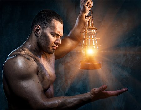 Muscular man holding oil lamp Fotografie stock - Microstock e Abbonamento, Codice: 400-07747004
