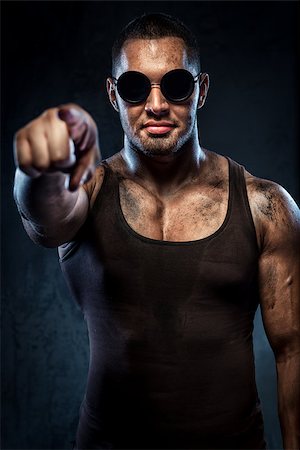 finger muscles - Muscular handsome young man in sunglasses pointing on you Stock Photo - Budget Royalty-Free & Subscription, Code: 400-07747008
