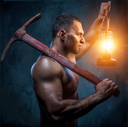 Muscular man holding pickaxe and oil lamp Fotografie stock - Microstock e Abbonamento, Codice: 400-07747003